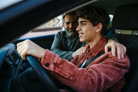 Father teaching his son to drive