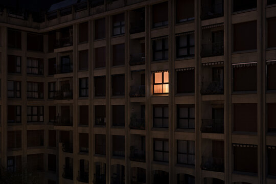 Lonely illuminated apartment window at night