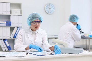 Obraz premium Quality control. Food inspectors checking safety of products in laboratory