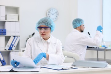 Quality control. Food inspectors checking safety of products in laboratory