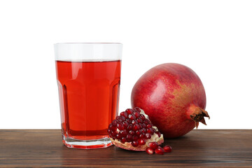Refreshing pomegranate juice in glass, leaves and seeds on wooden table against white background