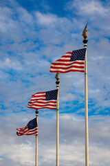 US American flag waving in the wind with beautiful blue sky in background. American flag on blue sky USA. Flag waving. Independence day. 4th of july. Vote.