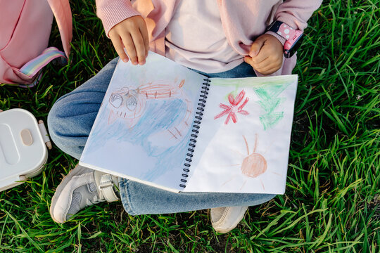 Child's colorful drawings in sketchbook