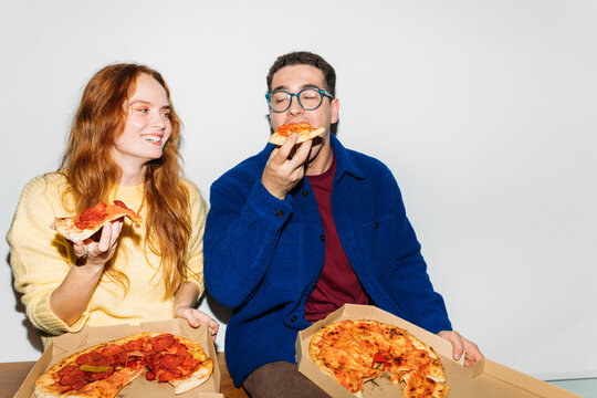 Couple eating pizzas
