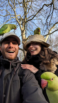 UGC selfie of couple with parakeets