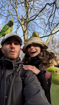 UGC selfie of couple with parakeets