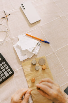 Senior man counting the money and making calculation 