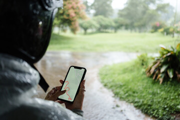 Motorcyclist Using Smartphone Navigation in Rain