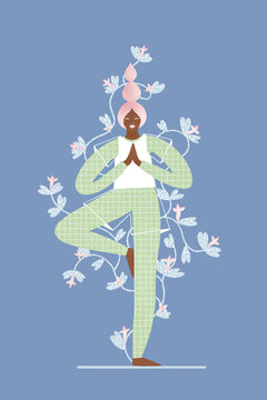 Barefoot black woman standing in vrikshasana while relaxing at home