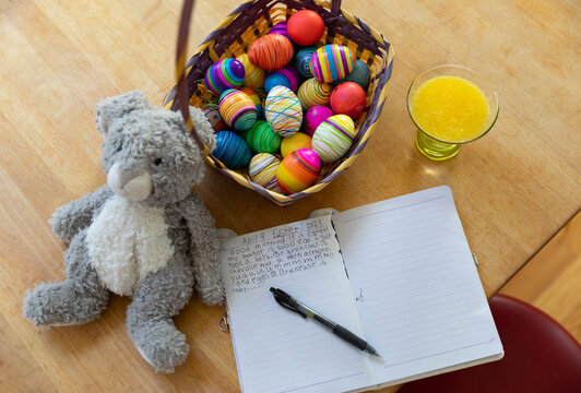 Colorful Easter Eggs in Basket with Note from child 