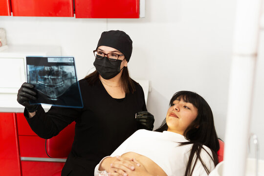Dentist showing x-rays to his patient.
