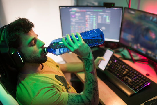 Gamer drinking water during gaming break 