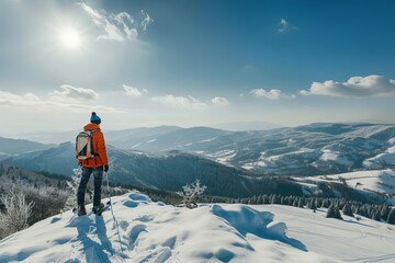 Naklejka na ściany i meble young man enjoying winter sports in snowy mountain landscape adventure and outdoor activities panoramic view