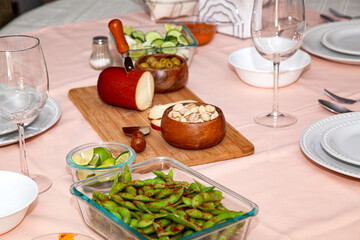 Still life of cold meats and crystal glasses to receive a tasty red wine.