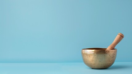 Golden singing bowl with wooden mallet on blue background - obrazy, fototapety, plakaty