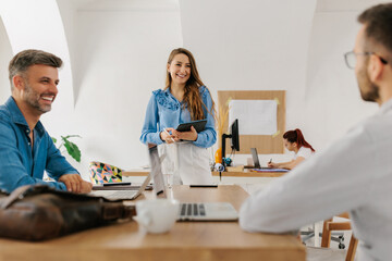 Young female leading a meeting in office 