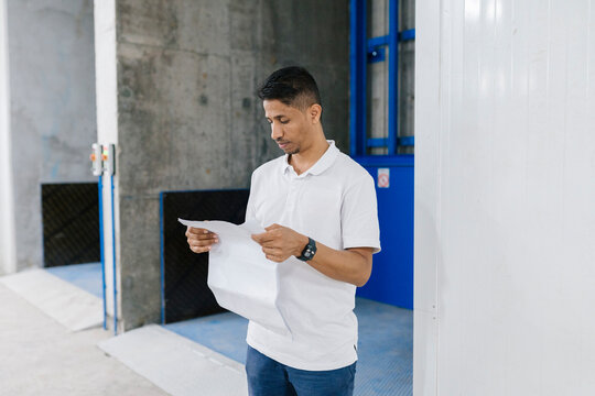 CCTV installer reading document about project
