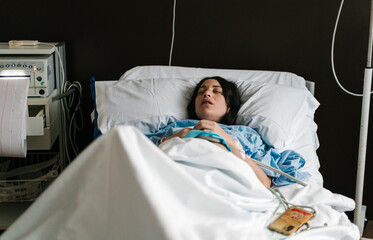 Pregnant Female patient sleeping in hospital room during treatment