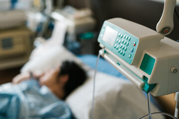 Intravenous infusion pump and patient in hospital
