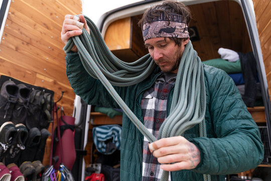 Climber flaking rope 