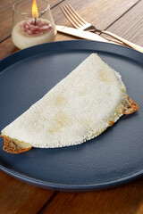 Melted mozzarella cheese tapioca, next to a cup of black coffee. Traditional Brazilian food_7.