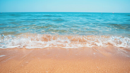 Fototapeta na wymiar Simple, blurry background of a sandy beach and calm sea.