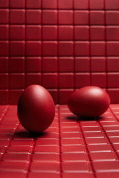 Two Red Eggs on Textured Surface