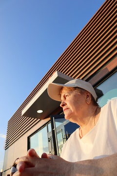 Senior Woman in Visor Enjoying Sunset