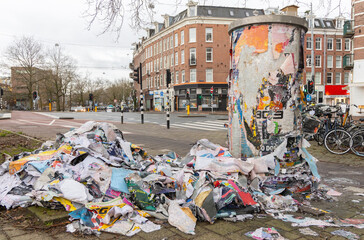 round bulletin board with torn posters