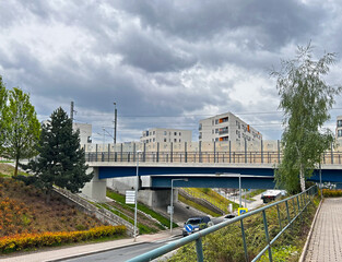 View of the city. Residential part of the city with traffic, road underpass and train overpass railway line.