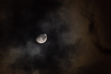 Naklejka na ściany i meble Full moon in the night sky with dark clouds, closeup of photo