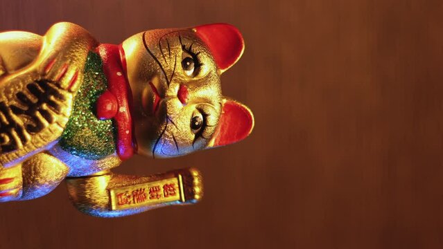 Vertical video of Japanese Waving Cat statuette called Maneki-Neko which is said to bring luck and wealth to a business.