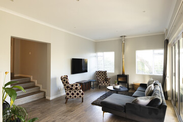 A cozy living room with modern furniture and fireplace warming up space