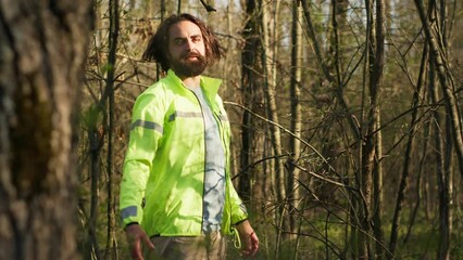 Rescue squad leader guiding route through the woods to collect evidence during searching operation to locate missing person. Shouting individual's name, civil disappeared in a forest. Camera A.