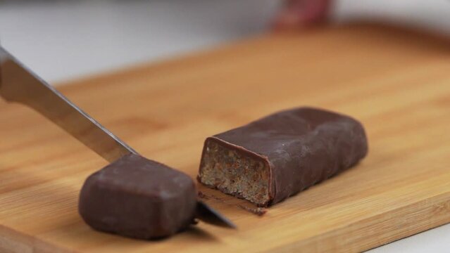 Cutting a candy bar with a knife on the cutting board