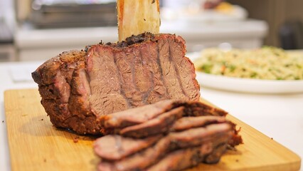 Roasted meat rests on table, tempting with its savory aroma The succulent meat promises flavorful experience inviting indulgence with each tender bite Enjoy the deliciousness of perfectly cooked meat