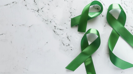 Emerald Green Cancer support ribbon for liver gallbladder bile duct kidney organ donation lyme disease mental health cerebral palsy blank plain background copy space healthcare fundraiser awareness