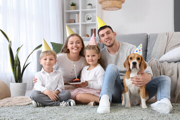 Happy family with Beagle dog celebrating Birthday at home