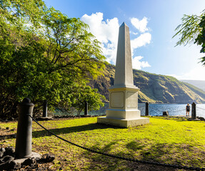 Female Hiker And Historical Catain James Cook Monument on The Shore of Kealakekua Bay, The Captain Cook Monument Trail, Captain Cook, Hawaii Island, Hawaii, USA