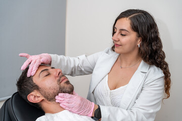 Male patient receiving facial skin rejuvenation treatment: doctor's skincare procedure for pampering and lifting