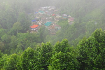 panorama of foggy and cloudy mountain village, on the slopes of himalaya mountains near darjeeling...