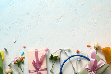 Stethoscope with ampules, gift boxes and flowers for International Nurses Day on light blue...