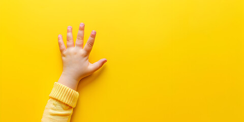 Children's palm on a yellow background with copy space Baby child boy hands on yellow  background Closeup