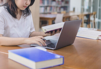 girl student study online with teacher, happy young woman with internet learning in library,...
