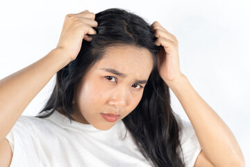 A woman with long hair is looking at the camera with a concerned expression.