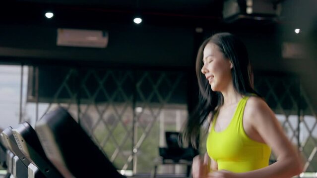 Young Asian Woman Running on Treadmill, Cardio Exercise at Fitness Gym Centre