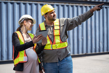 Middle east logistic worker foreman finger point with caucasian logistic worker pregnant woman at...