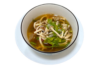 A steaming bowl of Isan mushroom soup, a fiery delight from Thailand's northeast region, entices the senses