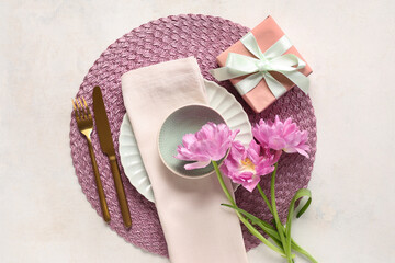 Fototapeta na wymiar Table setting with gift box and tulips on white background. Mother's day concept
