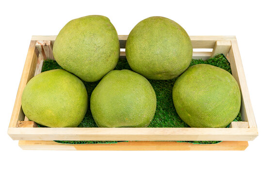 Pomelo in wooden crate isolated on white background